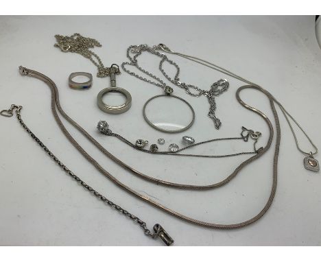 A quantity of white metal jewellery mostly marked .925 including chains, ring, two magnifying glasses on chains. Condition Re