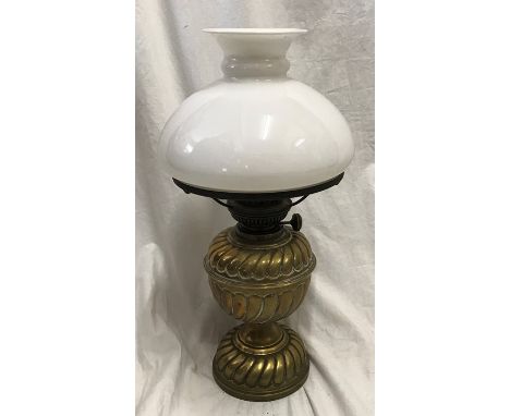 A Victorian brass oil lamp with milk glass shade, 43cms h with chimney flute. Condition ReportUnpolished, very good condition