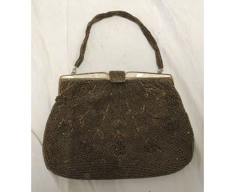 Ladies evening handbag, gilded bead floral decoration with mother of pearl to the clasp, 22cms w. Condition ReportSmall dirt 