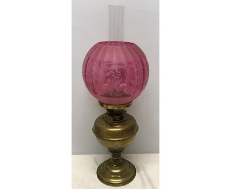 Brass oil lamp with acid etched cranberry colour glass shade, 52cms h to inner chimney top. Condition ReportGood condition, n