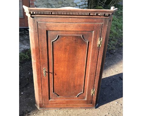 Oak corner cupboard, panelled door, 3 shelf interior, 68 w x 99cms h. Condition ReportLoose cornice right side corner, cracks