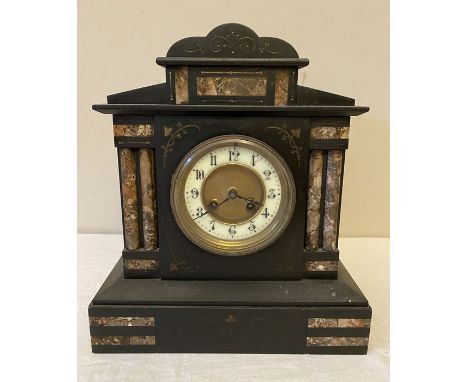 Black slate and marble mantle clock with 4 Corinthian columns with key, sounding on gong. 28 w x 32cms h. Condition ReportSom