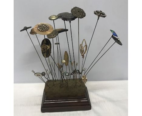 Hat pin cushion stand with a collection of 39 various hat pins including inlaid two silver tortoiseshell pique, needle worked