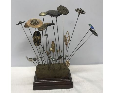 Hat pin cushion stand with a collection of 39 various hat pins including inlaid two silver tortoiseshell pique, needle worked