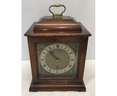 A 1940's walnut cased Smiths bracket clock with decorative brass face. Condition ReportVarnish loss to top front edge and ins