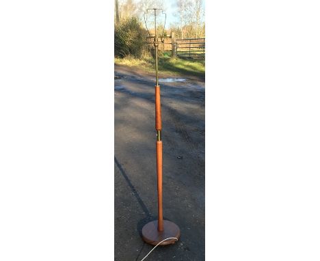 A 1970's teak and brass effect standard lamp. 142cms h. Condition ReportGood condition.&nbsp;
