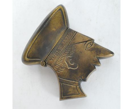 A vintage 20th century brass vest case in the form of a World War One WWI soldier with engraved features and Ypres 1915 Trenc
