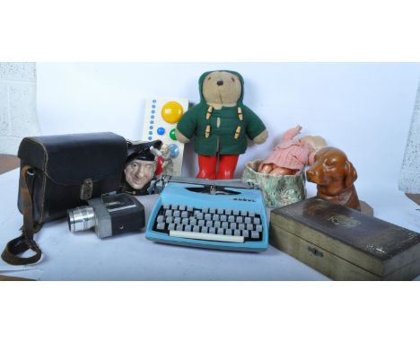 A large collection of 20th century curios comprising comprising of a Paddington style figure, Art Nouveau style tin, retro ty