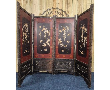 A Large Japanese four fold room divider screen. Each panel being hand carved, lacquered and showing a mother of pearl and bon