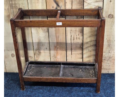 Early 20th century oak stick stand, having metal drip trays present. [68x68x25cm]