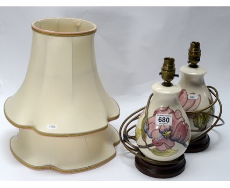 Moorcroft pair lamp bases decorated in the Hibiscus design on cream ground on wood bases, overall height 28.5cm  (2)
