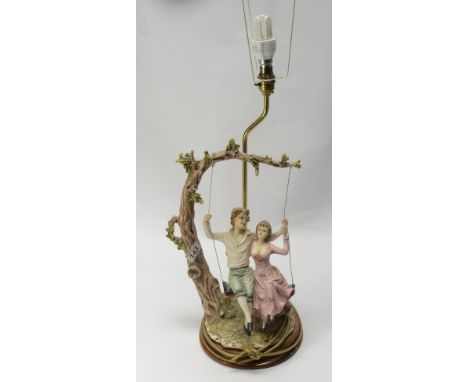 Large Capo de Monte style lamp base in the shade of young lovers on a tree swing