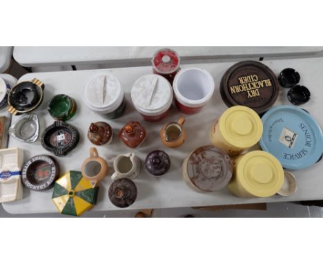 A collection of ceramic and plastic pub advertising ashtrays, jugs, ice buckets , trays etc