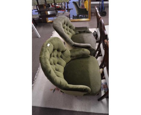 Two late Victorian green upholstered button back armchairs with slight differing designs to the legs