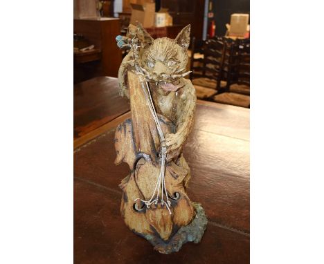 An unusual model of a cat playing a double base, the metal coloured in naturalistic style on a composite base, 63cm high