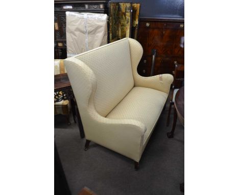 A Queen Anne style wing back two seater sofa on tapering legs