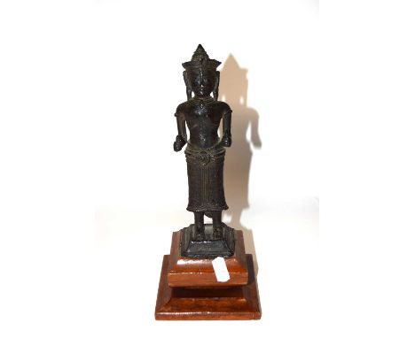 A metal model of a Hindu deity, probably South Indian on wooden plinth 26cm high