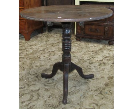 A 19th century oak country made occasional table the circular top raised on a ring turned pillar and tripod 76cm in diameter 