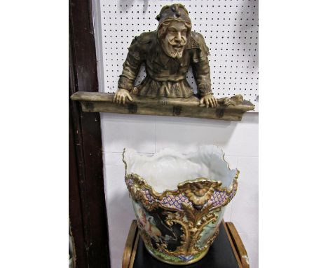 An unusual late 19th century continental pottery half length model of a jester in medieval style costume leaning over a parap
