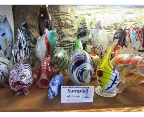 A massive collection of Murano glass fish of mainly typical form to include some paperweight examples also, (a large shelf fu