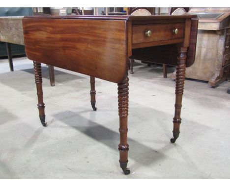 A 19th century mahogany Pembroke table on tapering bobbin supports 