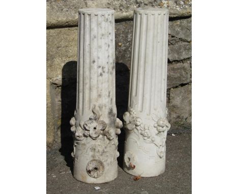 A pair of reclaimed architectural marble cylindrical column supports partially fluted with ring and trailing floral swag deta