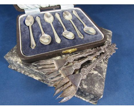 Cased set of silver coffee spoons, together with a further cased set of six Dutch white metal dessert forks with various figu