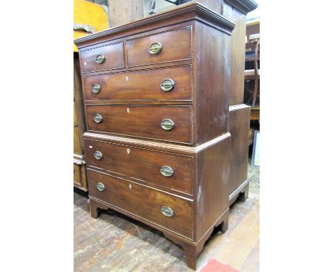 A small Georgian mahogany chest on chest of four long and two short graduated drawers, on bracket supports, with original bra