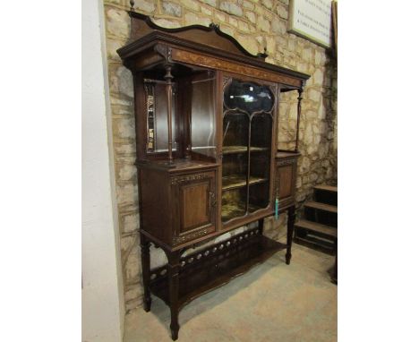 A good quality inlaid mahogany display cabinet enclosed by a central glazed panel door, flanked by two cupboards and open alc