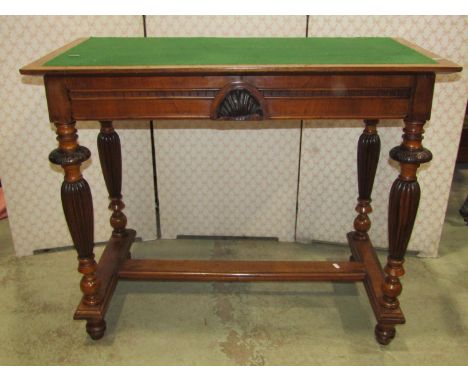 A walnut hall table with baise lined top, fitted with two slender side frieze drawers, raised on four turned and fluted suppo