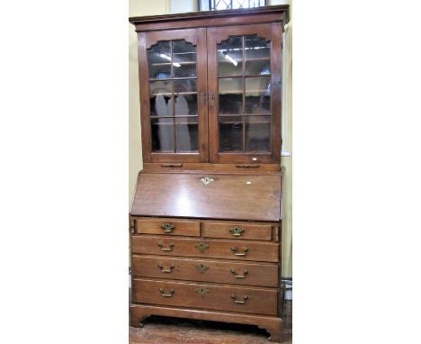 A Georgian mahogany bureau bookcase of three long and two short drawers, the fall flap with fitted interior, the upper sectio