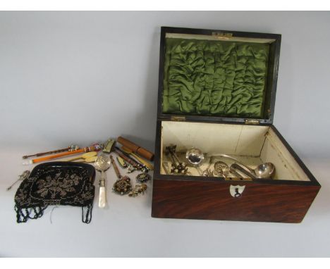 A walnut casket containing a collection of interesting items to include silver plated flatware, a Victorian beadwork purse, v