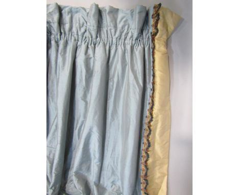 One pair of full length curtains in steel blue dupion silk with a contrasting brown silk band on leading edge and braid trim.