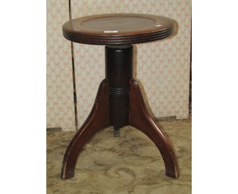 An Edwardian office or industrial stool, the circular dished top with rising mechanism and tripod base 