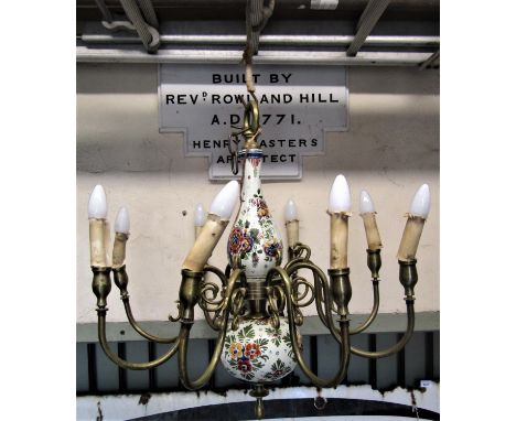 A cast brass effect hanging ceiling light/electrolier with eight scrolling branches surrounding a hand painted ceramic stem w
