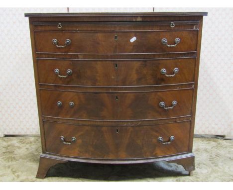 An Edwardian mahogany bow fronted chest of four long graduated drawers, together with a brush slide, raised on bracket suppor