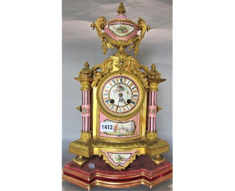 A good quality 19th century French ormolu Sevres type porcelain panel mantle clock, mounted by a twin handled urn, the twin t