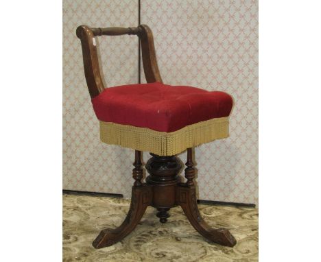 A Victorian musicians chair with upholstered seat, with adjustable height, the central column set within three turned spindle