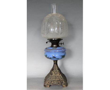 Edwardian cast metal oil lamp with tapered square base cast with various flowers, painted blue glass reservoir, 50cm high inc