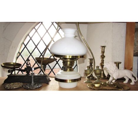 A collection of brassware to include a good pair of lidded cup and cover vessels, various candlesticks and lanterns, pair of 