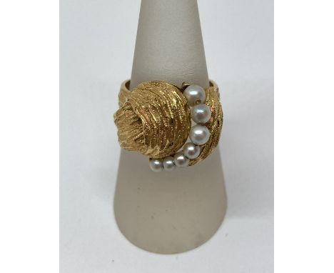 Stylised gold ring set with graduated pearls, foreign stamps to outer shank, size O, 6.9g 