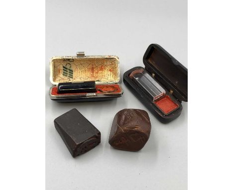 A Chinese horn cased seal and inkpad, another in a leather mounted case together with European wood and red stone seals
