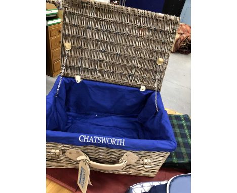 A Chatsworth House basket work hamper containing a tartan rug and a cool box and together with a wicker two bottle champagne 