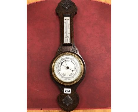 An oak banjo aneroid barometer with a mercury thermometer above the dial.   H 60cms.