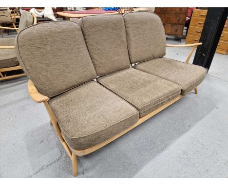 An Ercol triple windsor spindle back settee /sofa with lose seat cushions.