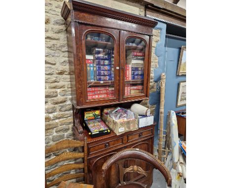 A mahogany side cabinet, the upper half with glazed doors enclosing shelves above an open shelf top to the base with two draw