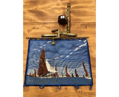 A late Victorian gilt metal wall mounting adjustable firescreen arm with a needlework banner depicting yachts with brown sail