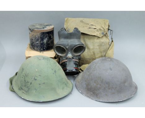 Two tin helmets and four gas masks, mainly WWII army and civilian. 