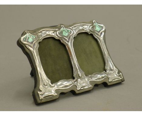 An Art Nouveau style silver double photograph frame. 11 cm wide.