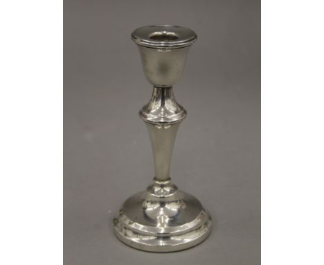 A silver candlestick, hallmarked for Birmingham 1954. 15 cm high.